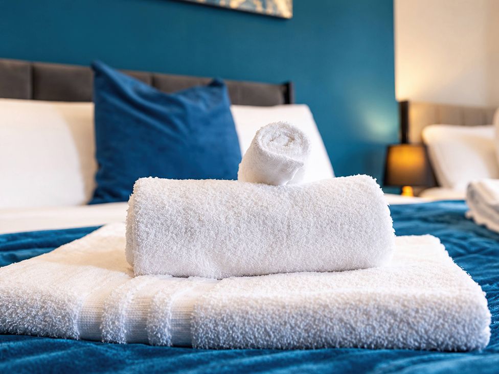 A towel arrangement on a bed at 20A Westend Parade in Gloucester