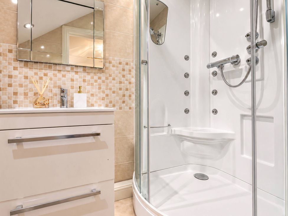 A bathroom with a shower and sink at 20A Westend Parade in Gloucester