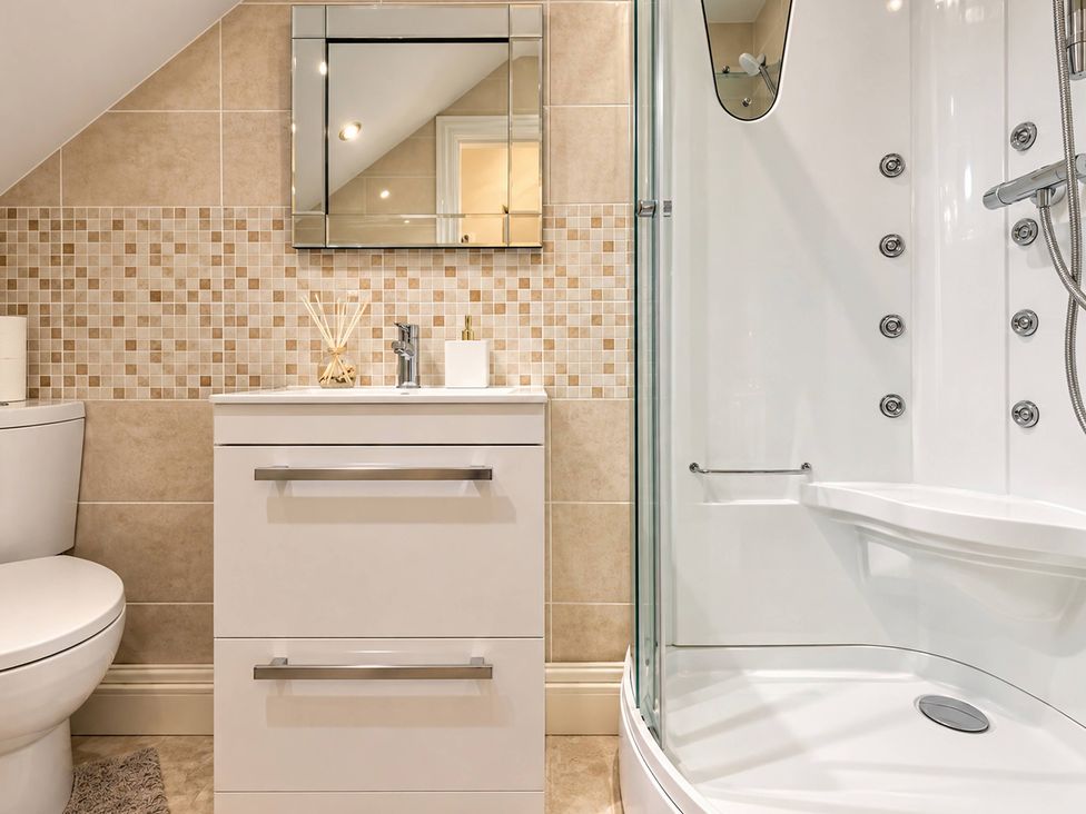A bathroom with a shower, sink, and toilet at 20A Westend Parade in Gloucester