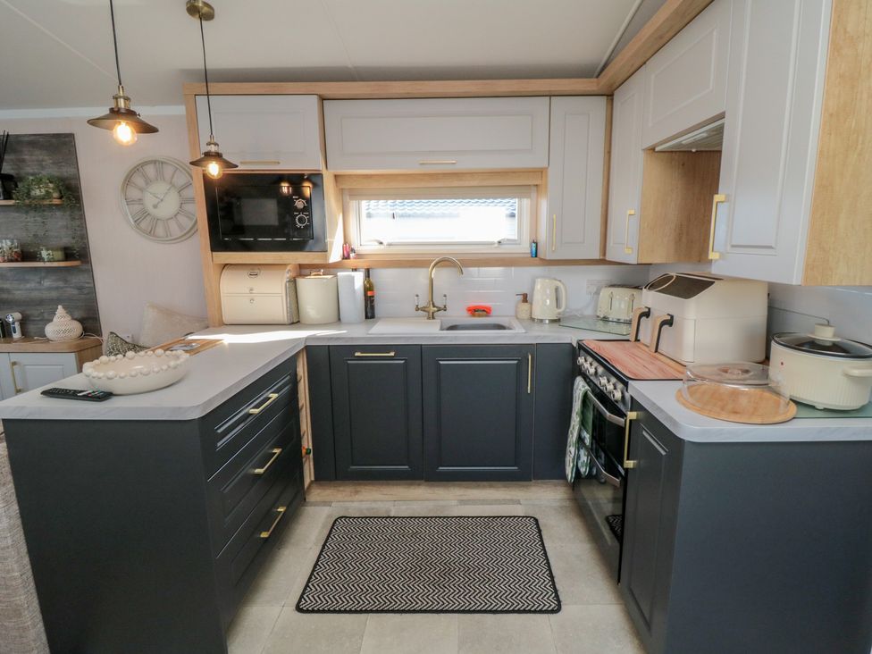A kitchen with cabinets, sink, stove, and appliances at 19 Finch in 