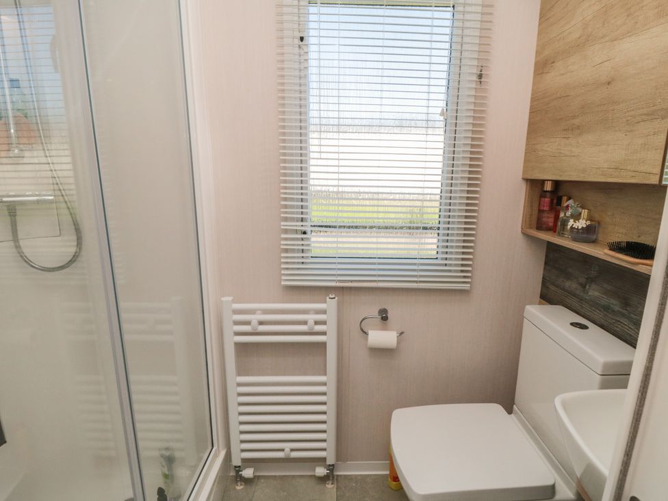 A bathroom with a shower and toilet at 19 Finch