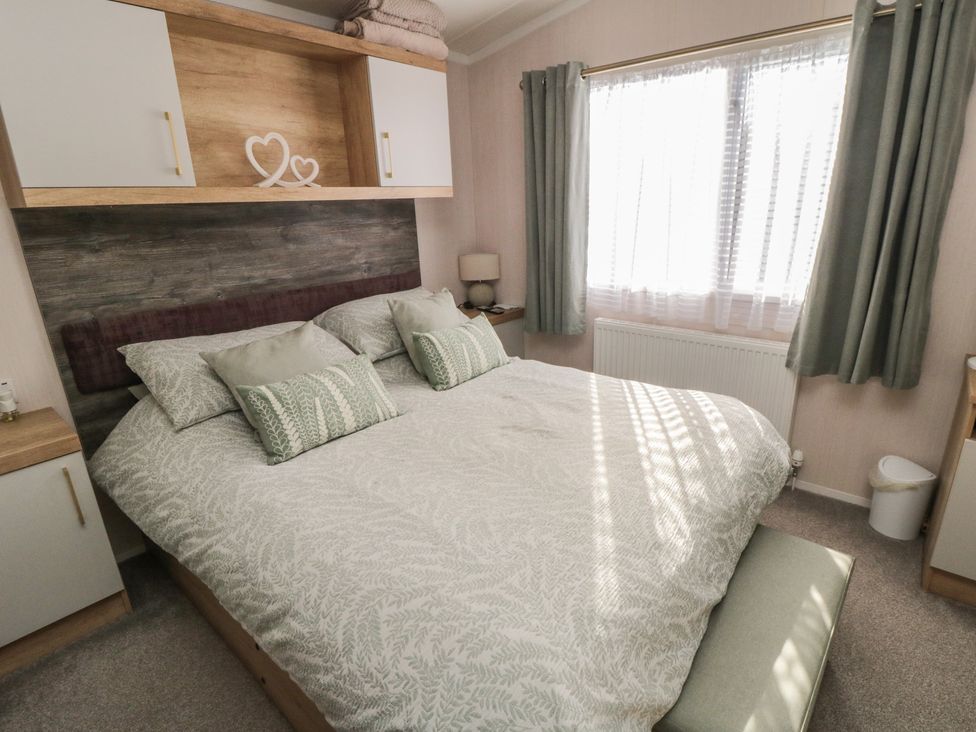A bedroom with a double bed and a window at 19 Finch