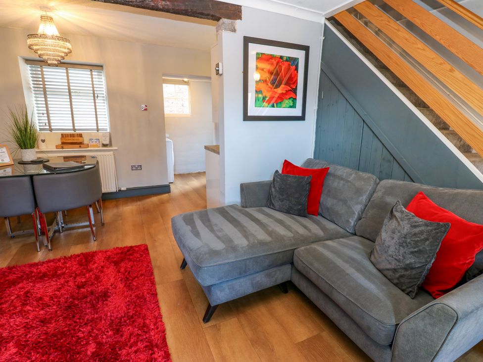 A living room with a sofa and dining table at Crown Cottage in Appleby-In-Westmorland