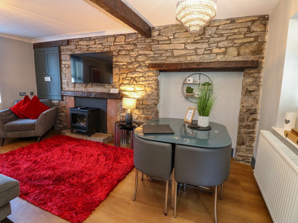 A living room with a sofa and a table at Crown Cottage in Appleby-In-Westmorland