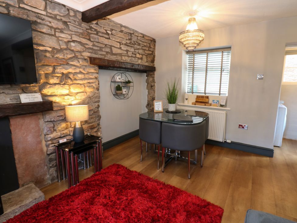 A living room with a table and chairs at Crown Cottage in Appleby-In-Westmorland