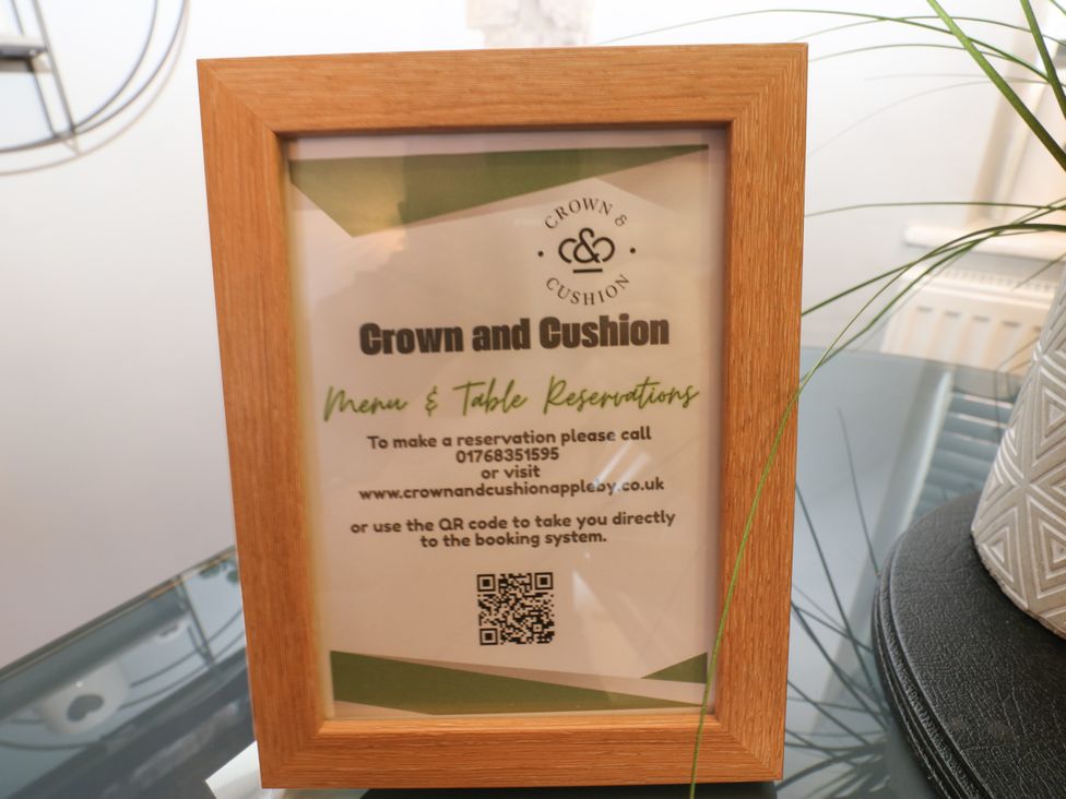 A menu and table reservation sign framed at Crown and Cushion in Appleby-In-Westmorland