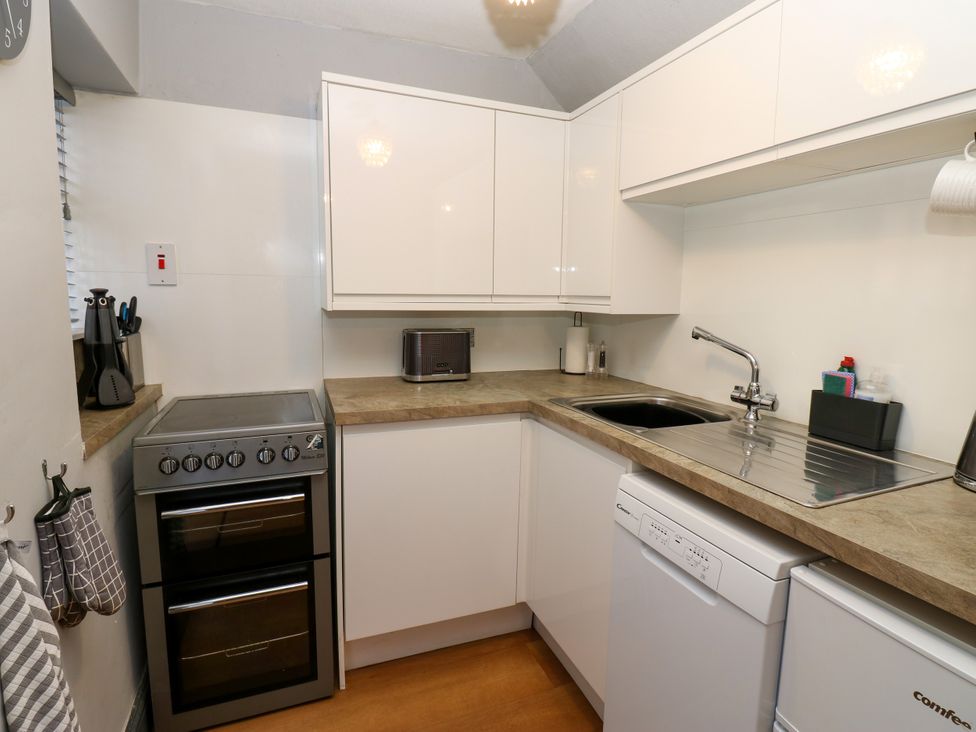 A kitchen with an oven, sink, and countertop at Crown Cottage Appleby-In-Westmorland