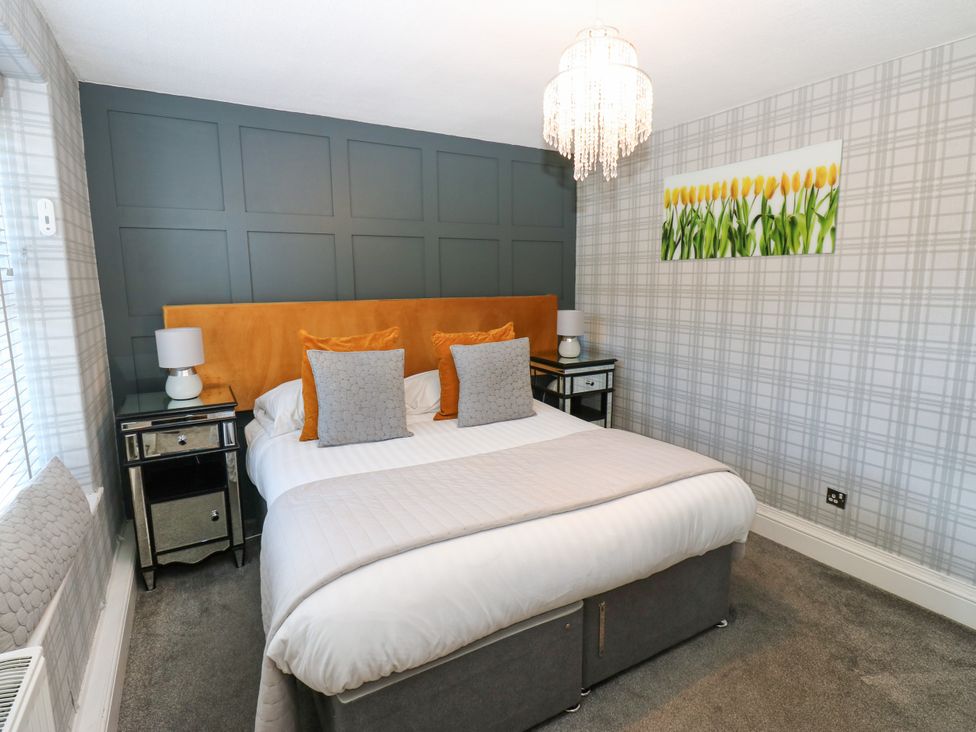 A bedroom with a bed and bedside table at Crown Cottage in Appleby-In-Westmorland