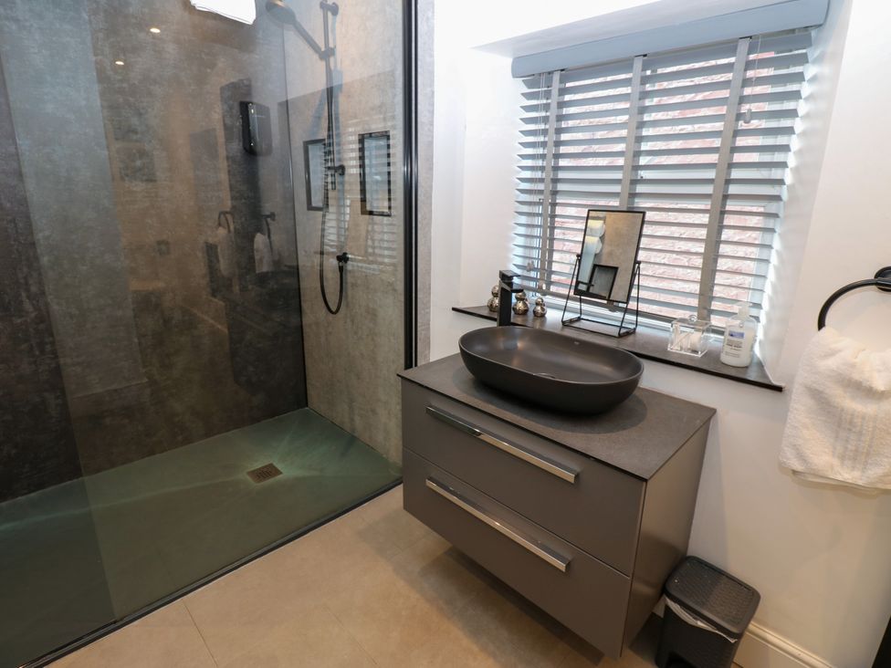 A bathroom with a shower and basin at Crown Cottage in Appleby-In-Westmorland