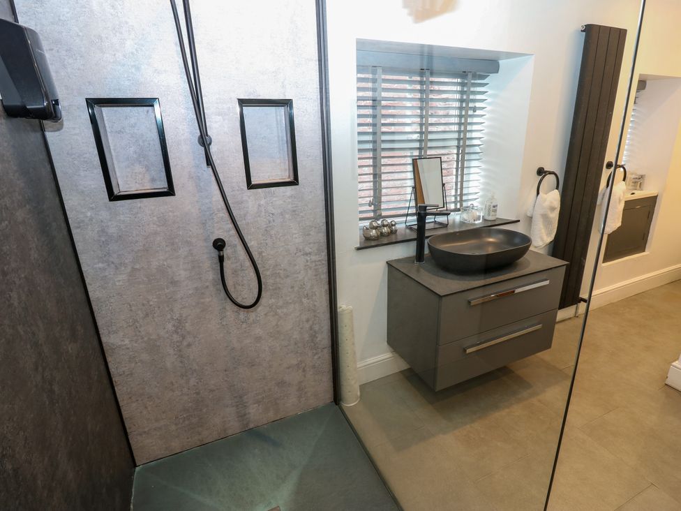 A bathroom with a shower and sink at Crown Cottage in Appleby-In-Westmorland