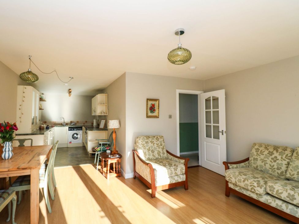 A living room and kitchen area with furniture at Moness Garden Studio, Aberfeldy