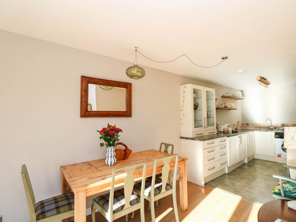 A dining room with a table and chairs at Moness Garden Studio in Aberfeldy