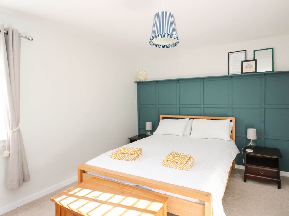 A bedroom with a bed and bedside tables at Moness Garden Studio Aberfeldy