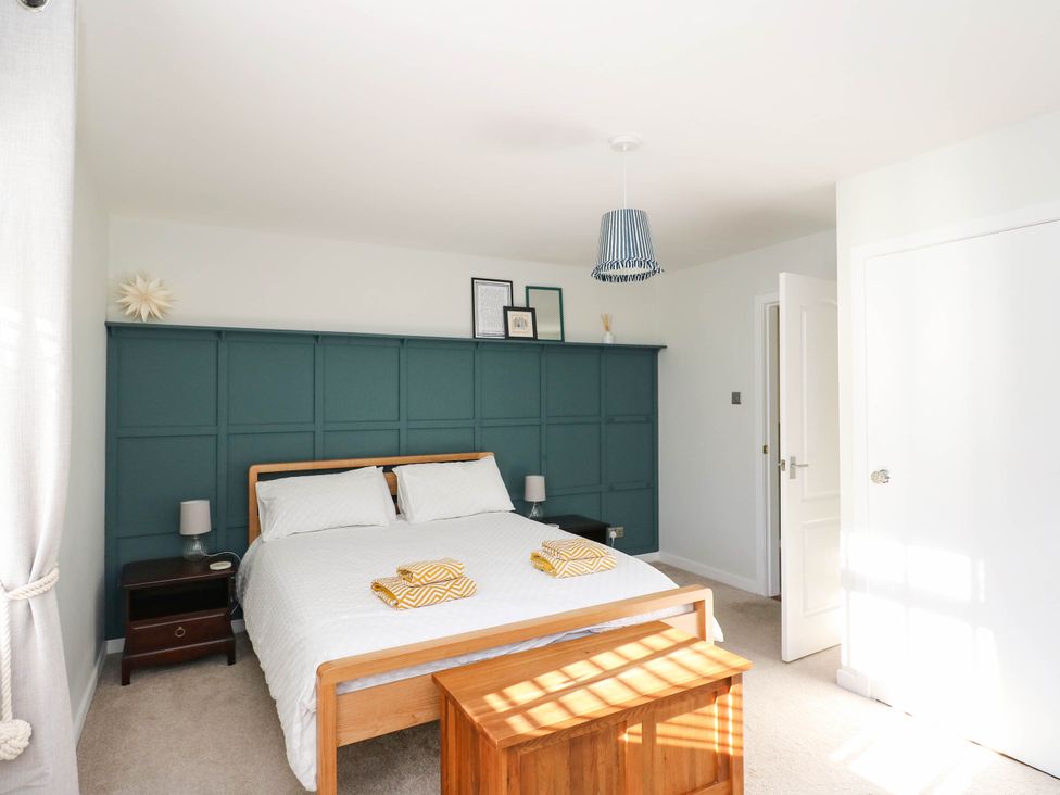 A bedroom with a bed and bedside table at Moness Garden Studio Aberfeldy