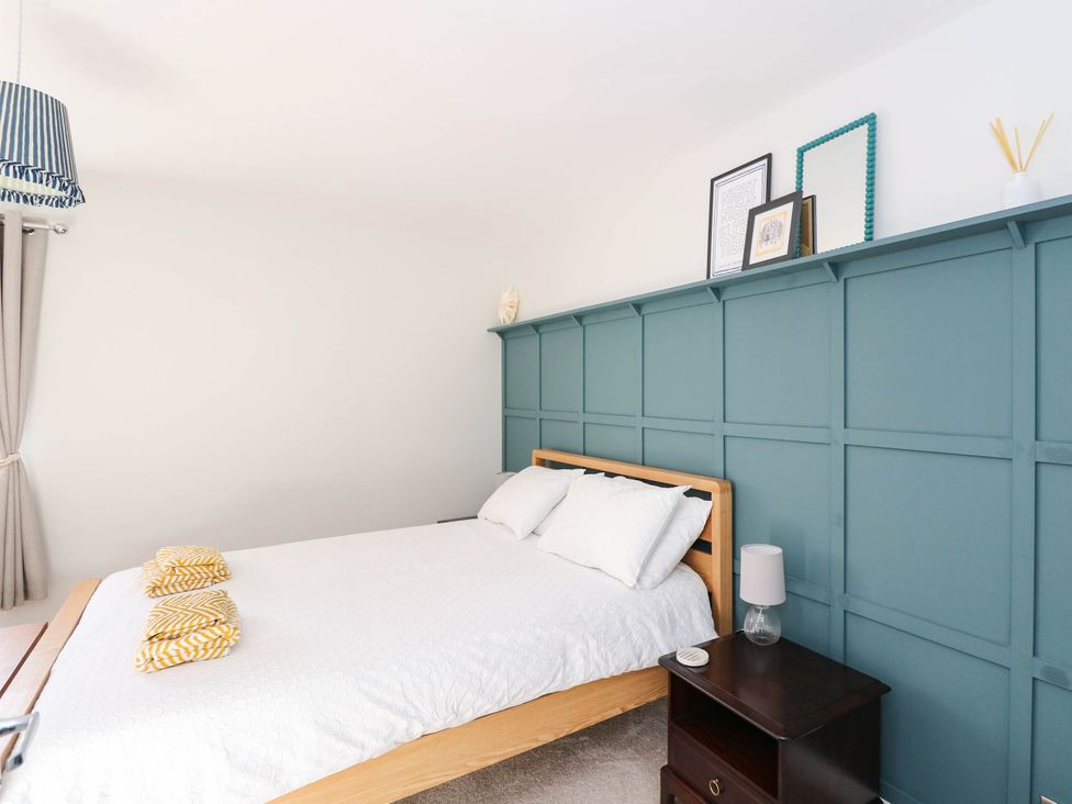 A bedroom with a bed and bedside table at Moness Garden Studio in Aberfeldy