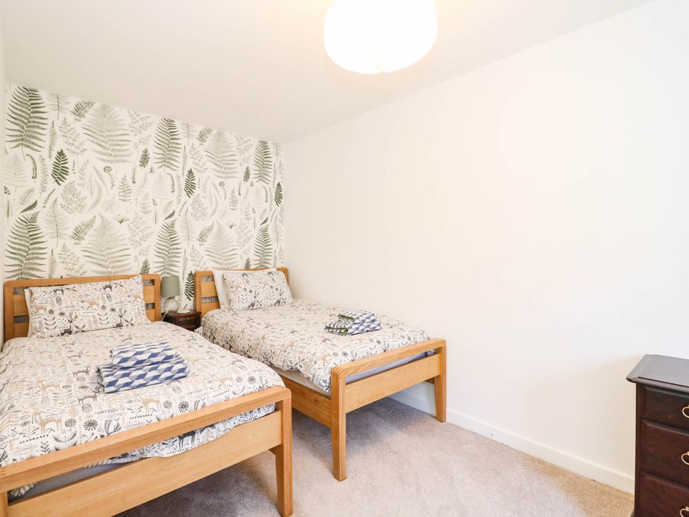 A bedroom with two beds and a dresser at Moness Garden Studio Aberfeldy