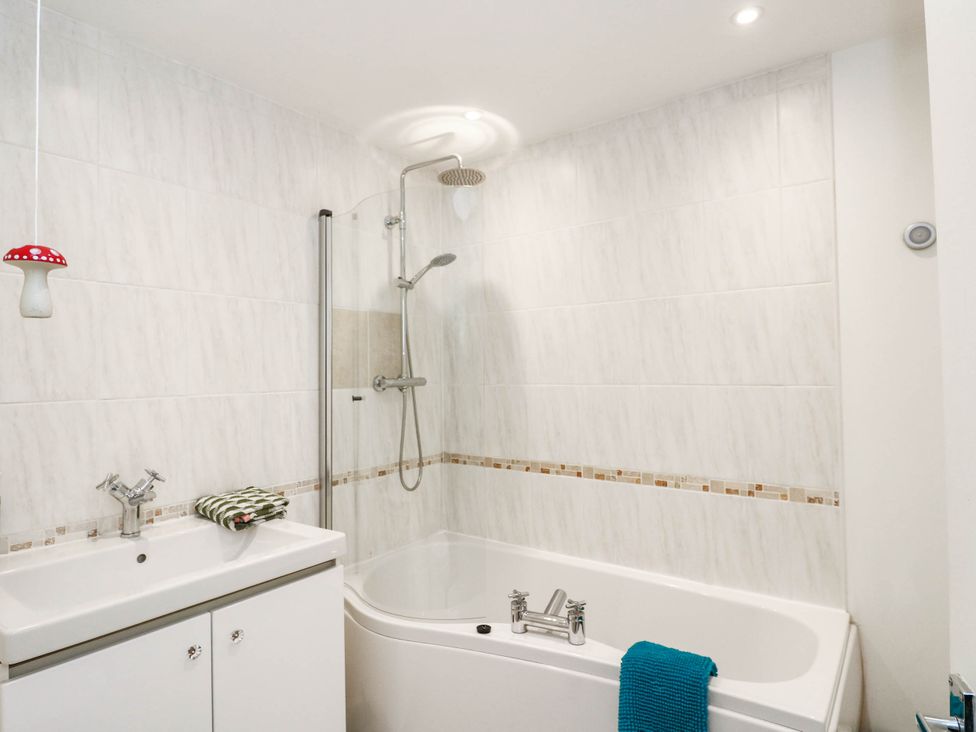 A bathroom with a bathtub and shower at Moness Garden Studio in Aberfeldy