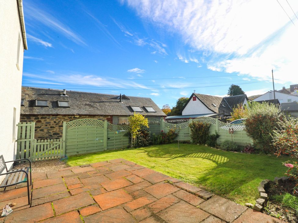 A garden with grass and patio at Moness Garden Studio, Aberfeldy