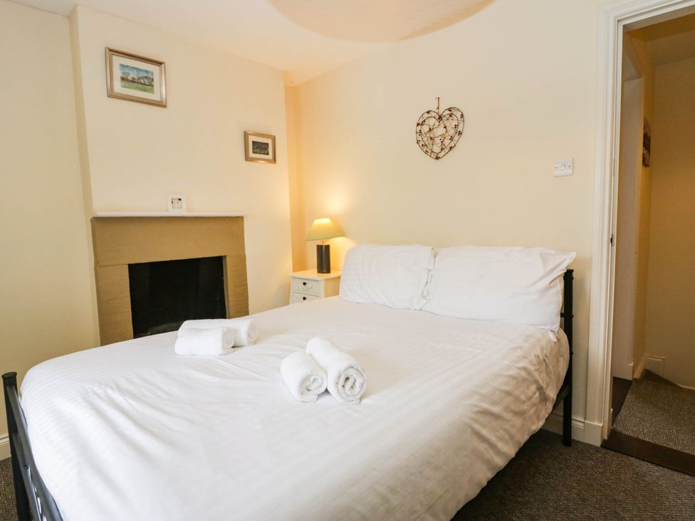 A bedroom with a bed and bedside table at Acorn in Cleator