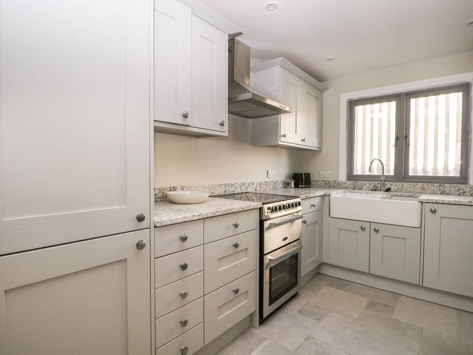 A kitchen with cabinets and appliances at The Granary 2 Bed in Bordon