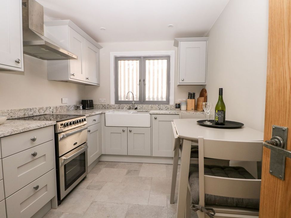 A kitchen with cabinets and appliances at The Granary 2 Bed in Bordon