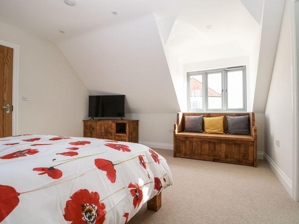 A bedroom with a bed and television at The Granary 2 Bed in Bordon