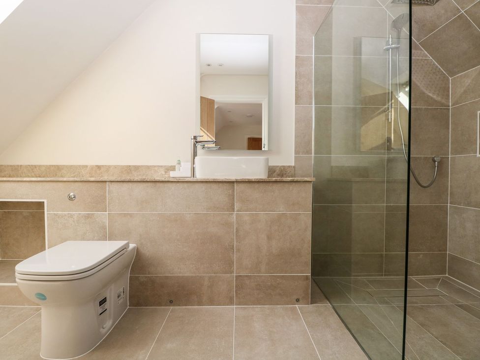 A bathroom with a toilet and shower at The Granary 2 Bed in Bordon
