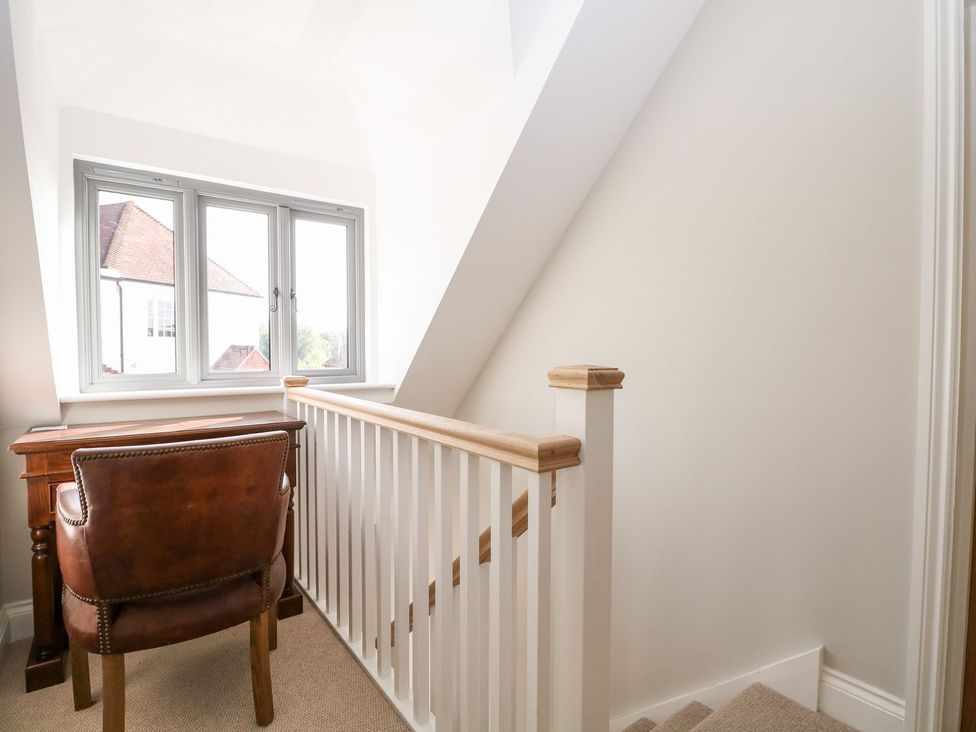 A landing area with a desk and chair at The Granary 2 Bed in Bordon