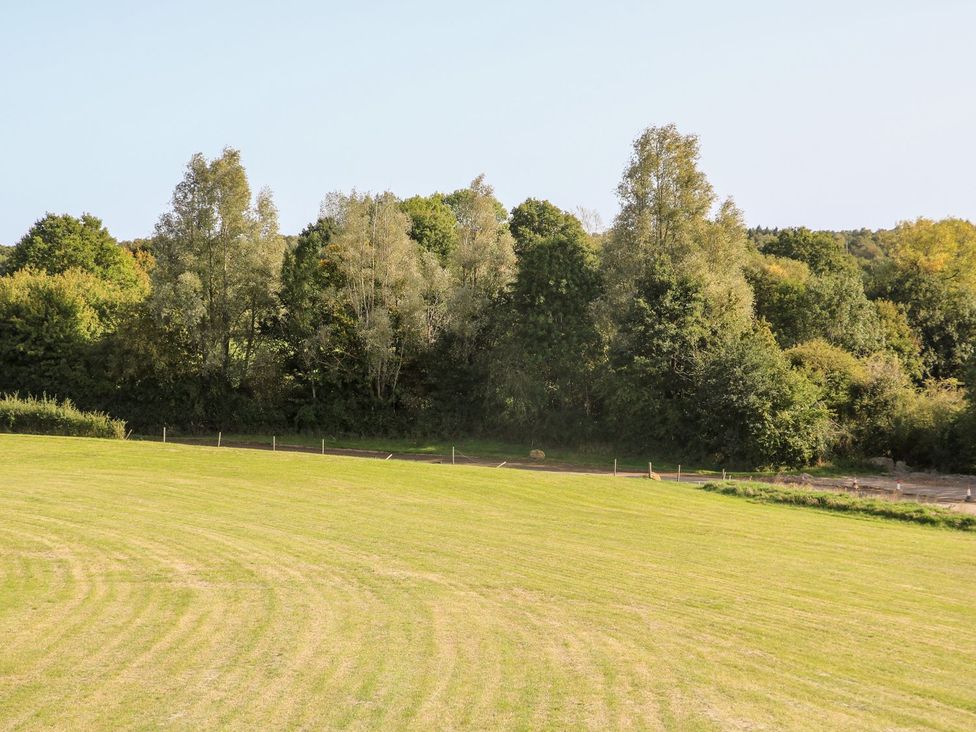A field with trees along the edge at The Granary 2 Bed in Bordon