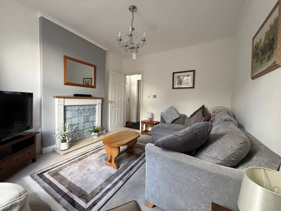 A living room with a sofa and coffee table at 9 Market View in Buxton