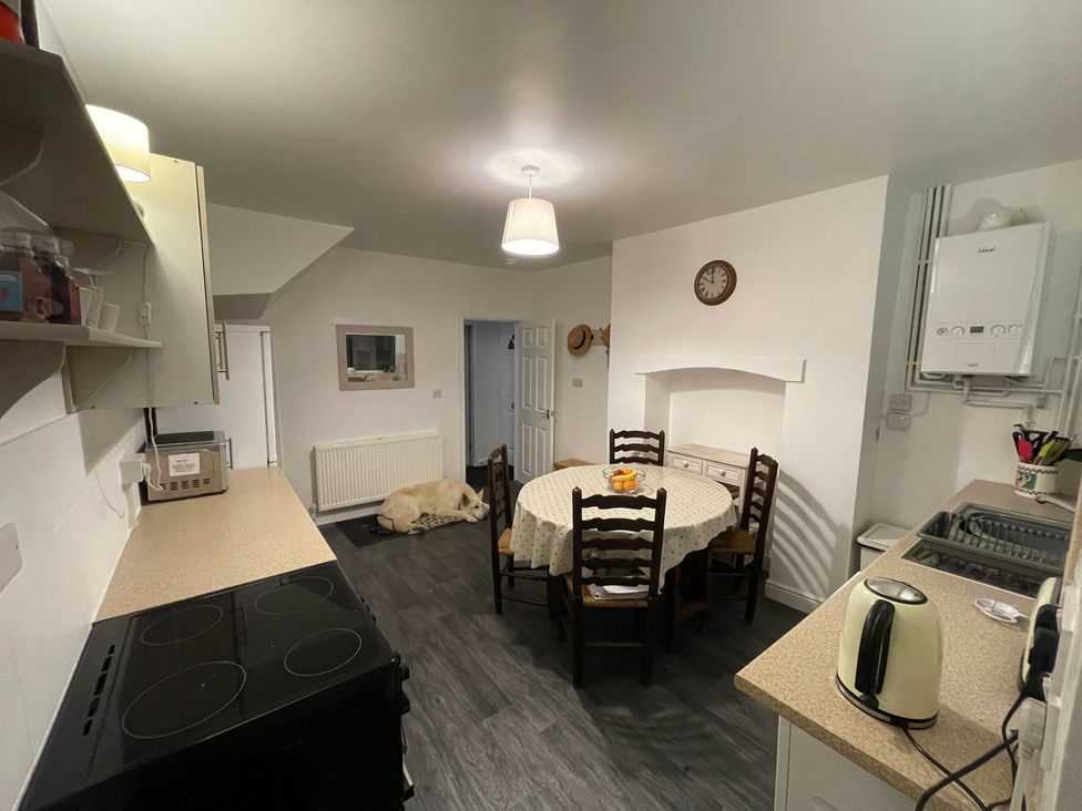 A kitchen with a round table and chairs at 9 Market View Buxton