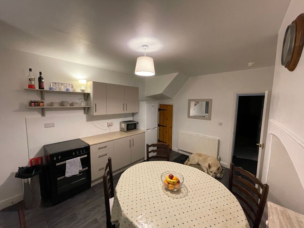 A kitchen with a table and fruit bowl at 9 Market View Buxton
