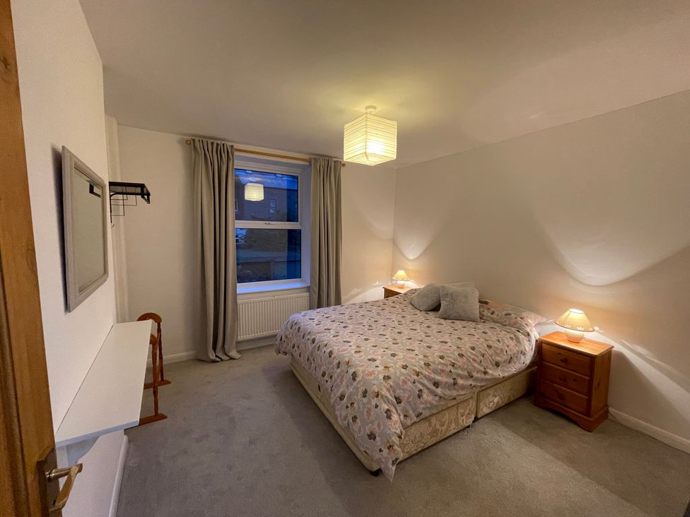 A bedroom with a bed and bedside tables at 9 Market View in Buxton