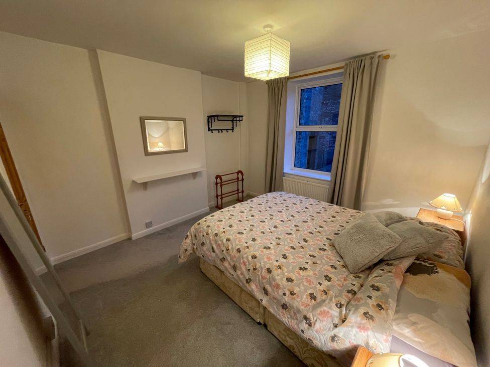 A bedroom with a bed and side table at 9 Market View Buxton