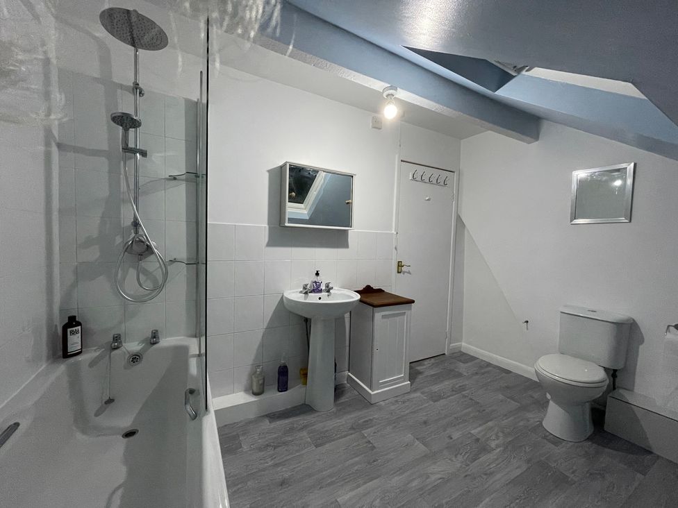A bathroom with a shower, sink, and toilet at 9 Market View in Buxton