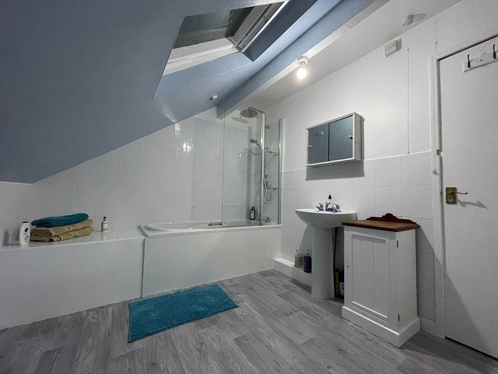 A bathroom with a bathtub and shower enclosure at 9 Market View Buxton
