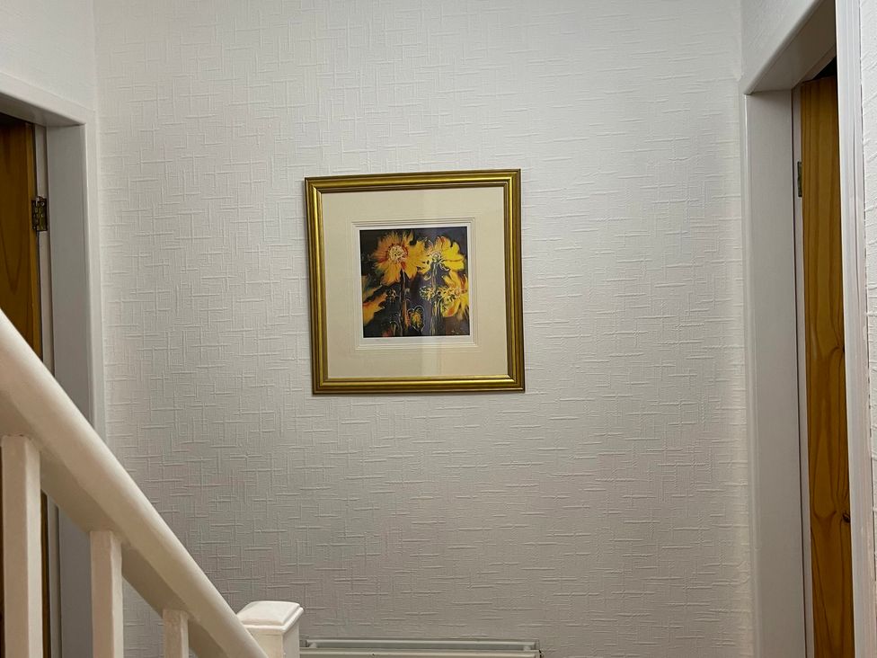A hallway with a picture on the wall at 9 Market View in Buxton