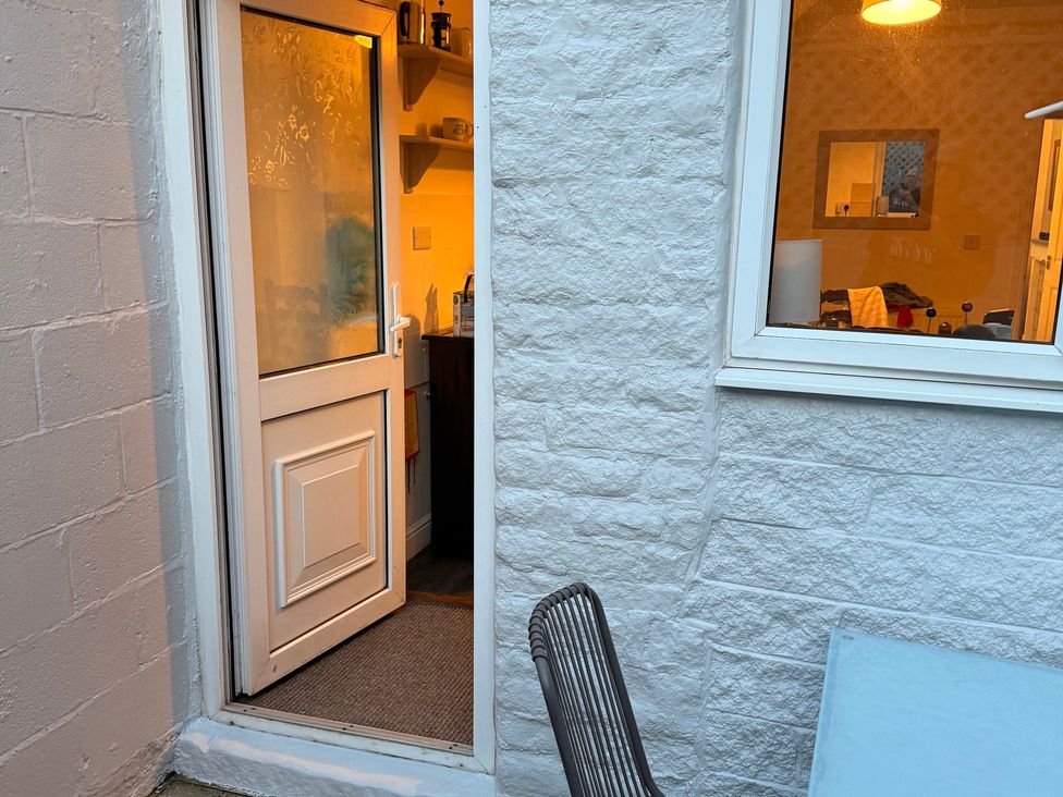 A door to the kitchen with a view of a window and furniture at 9 Market View Buxton