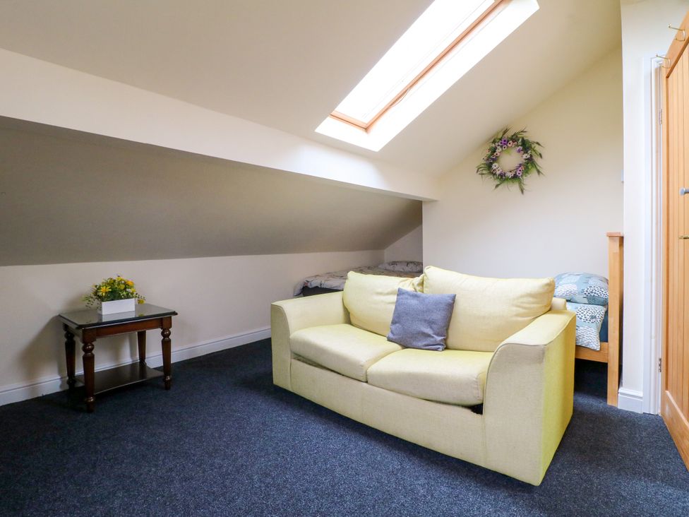 A sitting area with a sofa and a bed at Greystones - Apartment B near Buxton