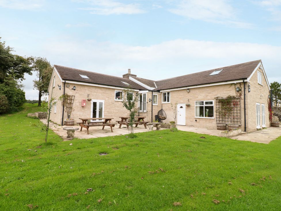 A house with patio furniture and garden space at Greystones - Apartment C near Buxton