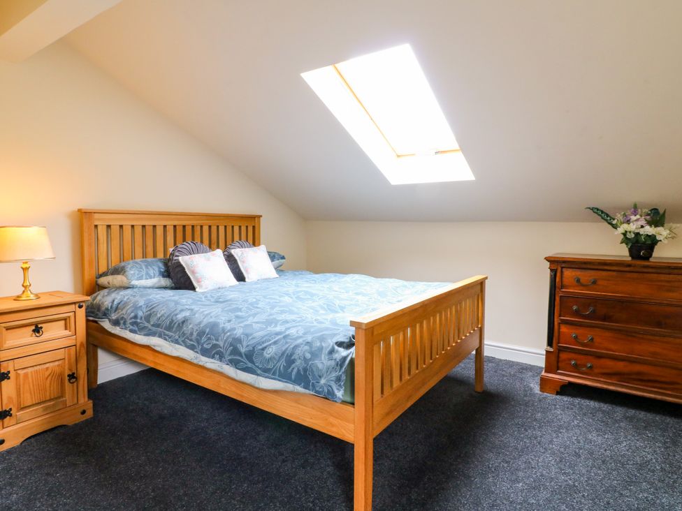 A bedroom with a bed and side table at Greystones - Apartment C near Buxton