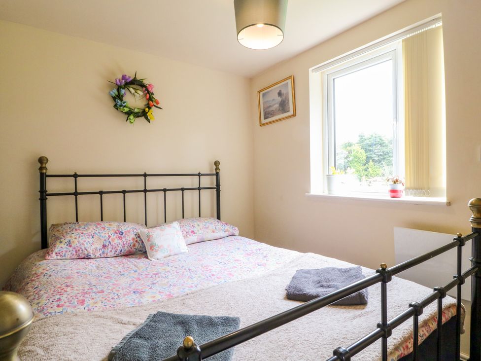 A bedroom with a bed and a window at Greystones - Apartment C near Buxton