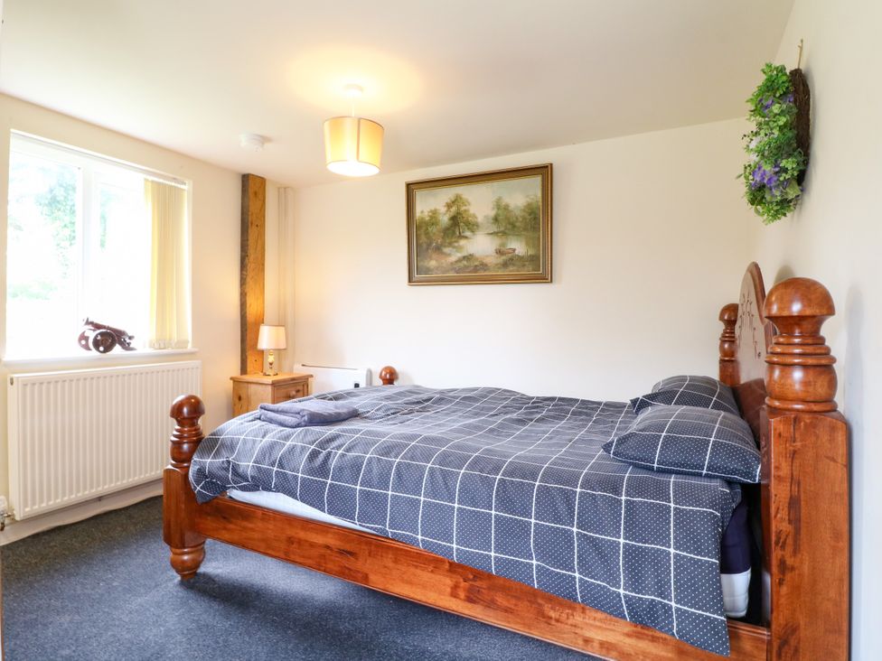 A bedroom with a bed and art at Greystones - Apartment C near Buxton