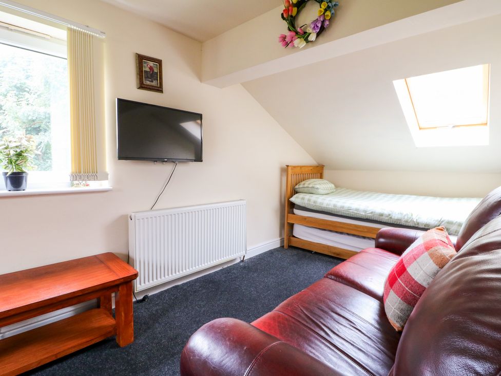 A bedroom with a bed and television at Greystones - Apartment C near Buxton