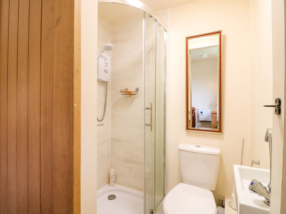 A bathroom with a shower, toilet, and sink at Greystones - Apartment C near Buxton