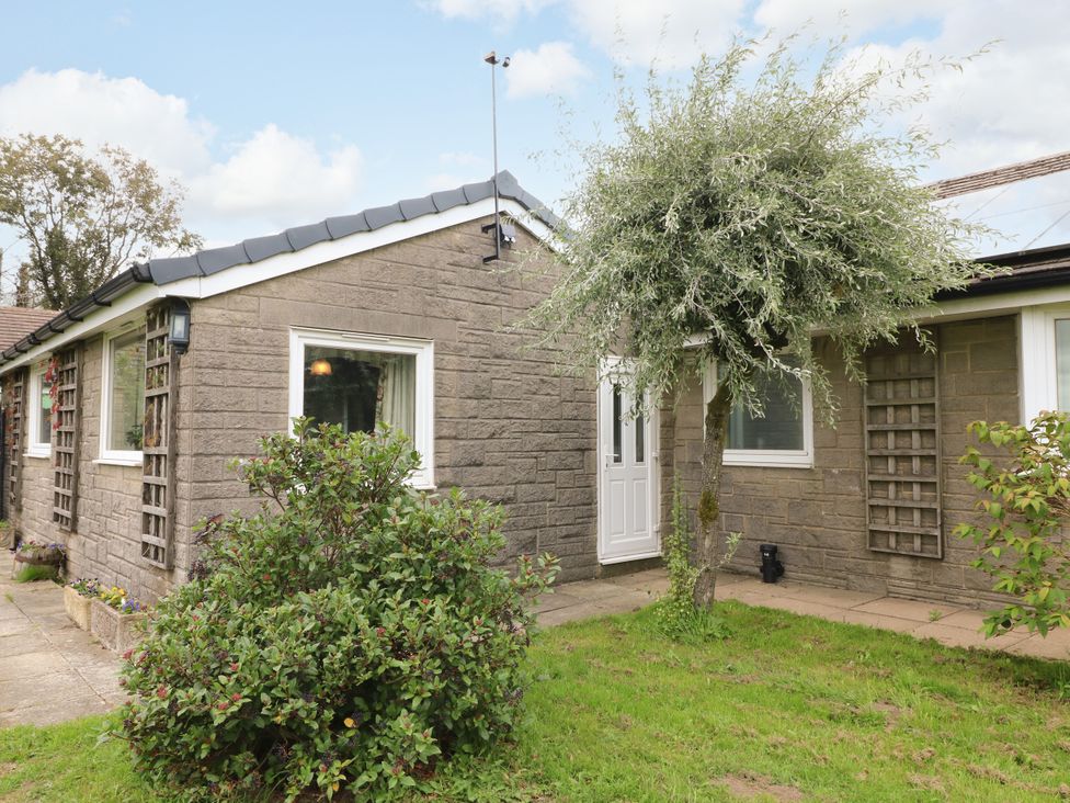 A house with a door and windows surrounded by a garden at Greystones - apartment D near Buxton