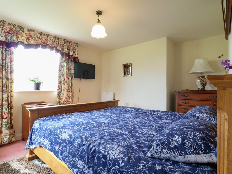 A bedroom with a television and a bed at Greystones - apartment D near Buxton