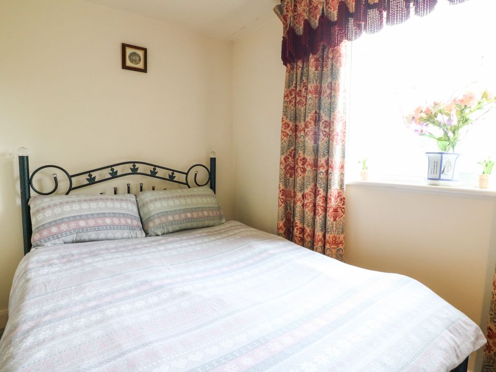 A bedroom with a bed and window at Greystones - apartment D near Buxton