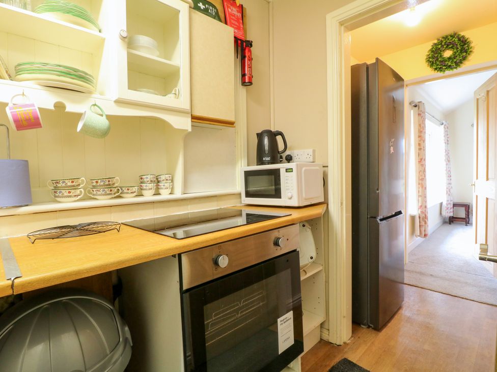 A kitchen with a refrigerator and microwave at Greystones - Apartment E near Buxton