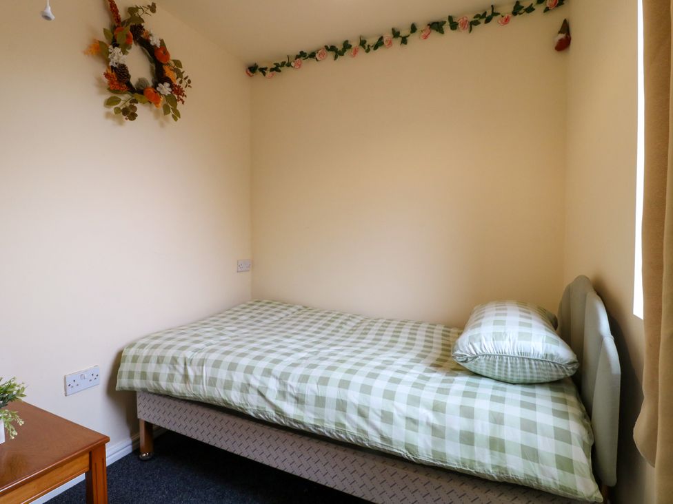 A bedroom with a single bed and a small table at Greystones - Apartment E near Buxton
